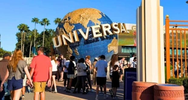 Visitors walk toward the Universal Studios globe during a lockdown.