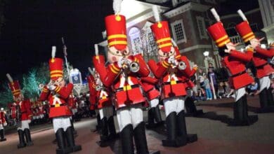 Toy soldiers march and play trumpets in Mickey’s Once Upon a Christmastime Parade at Disney World.
