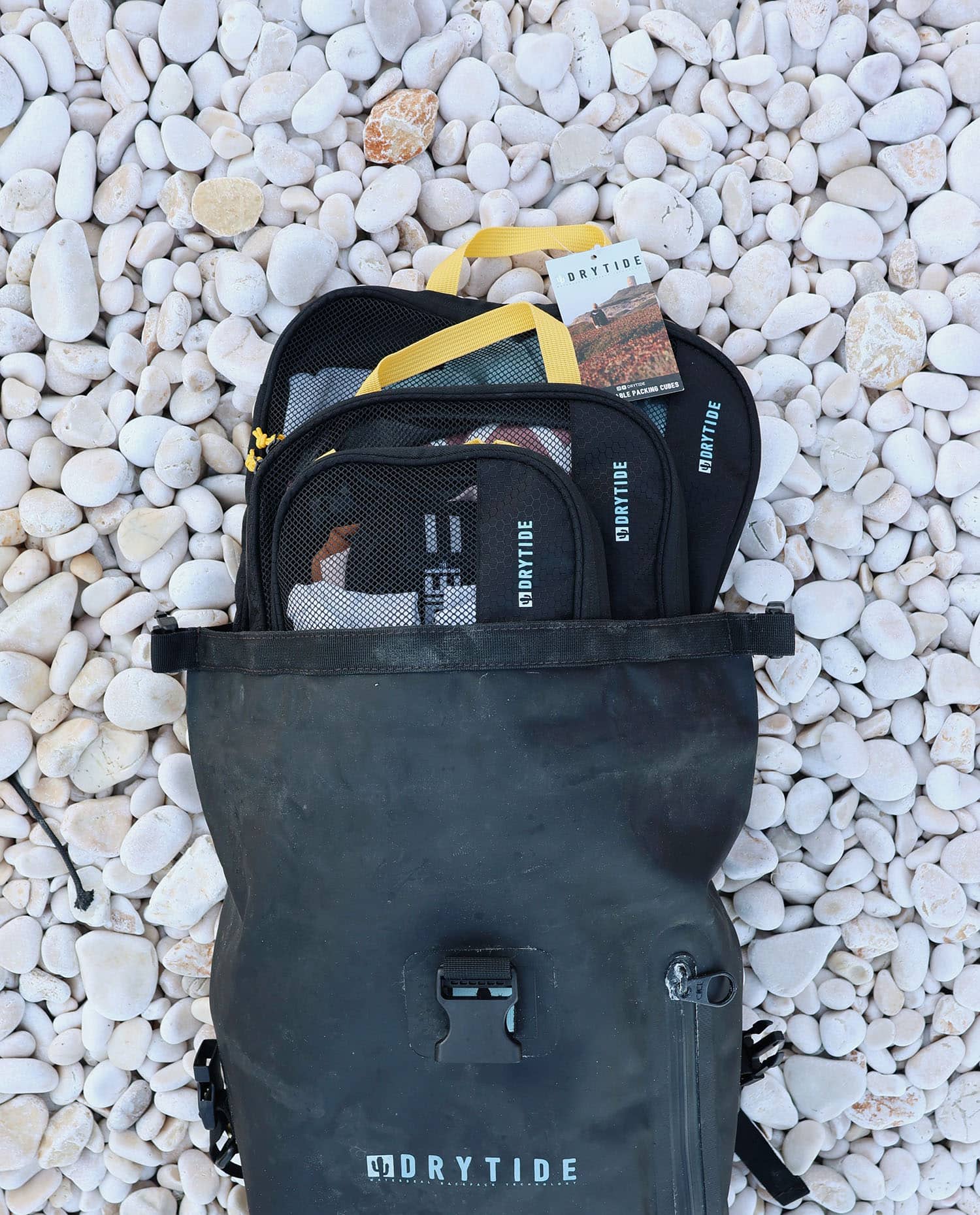 Drytide Waterproof Backpack and Duffel Bag on Pebbles Packing cubes inside a waterproof backpack