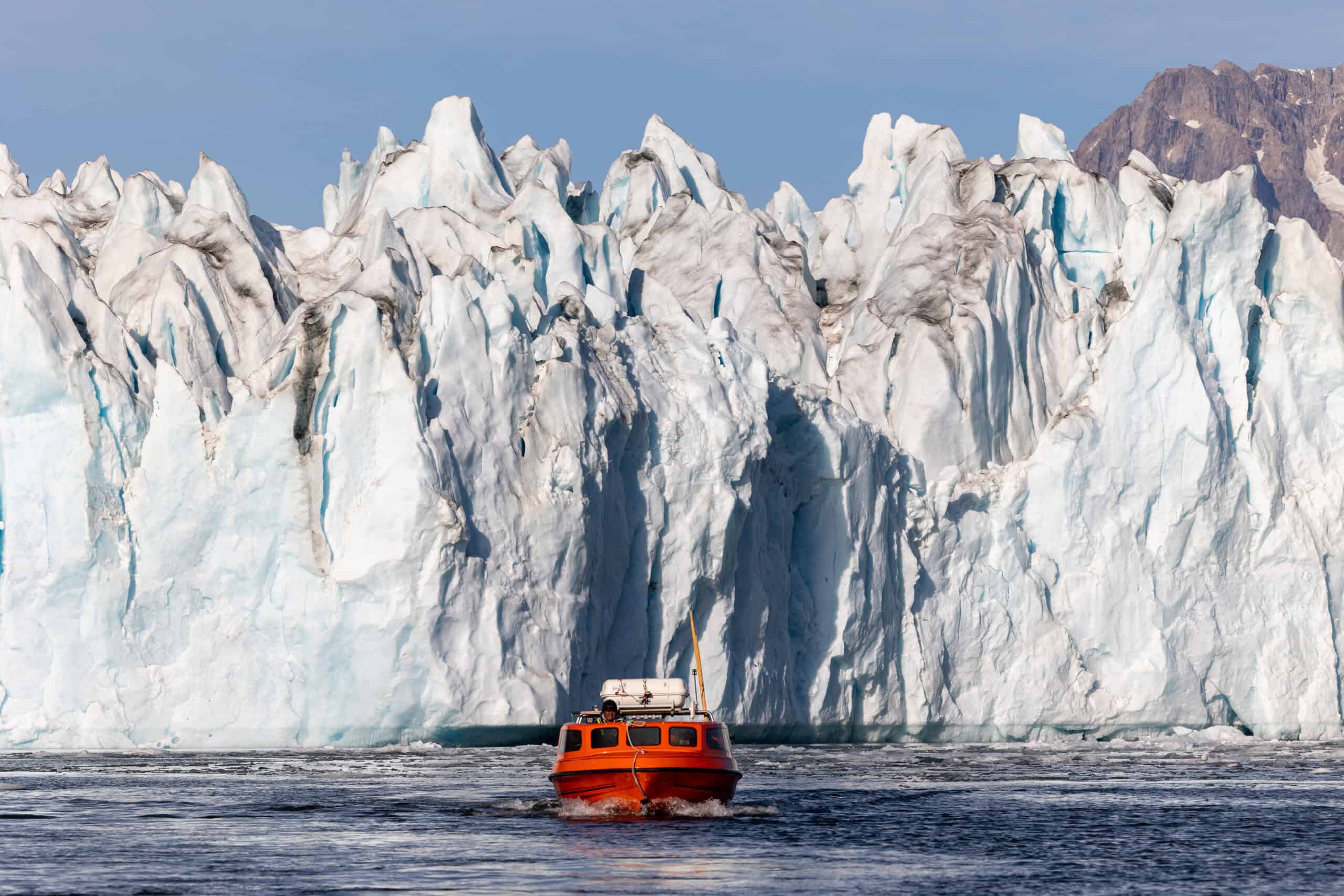Iconic poca boat in front of Knud Rasmussen Glacier.