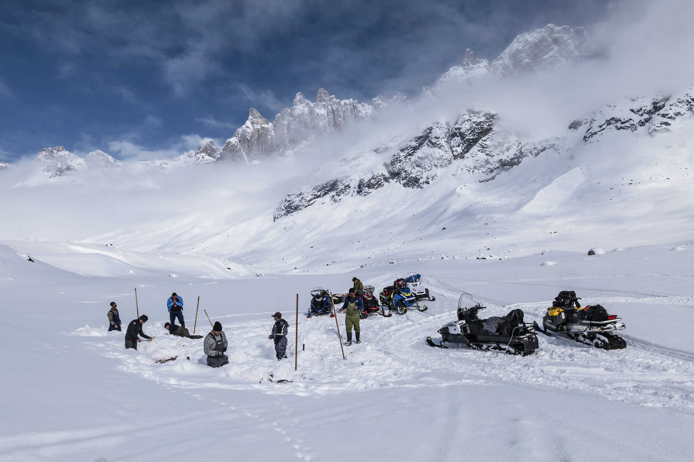 Joint ice fishing in the backcountry of East Greenland close to Kuummiut. Photo by Carsten Egevang - Visit East Greenland