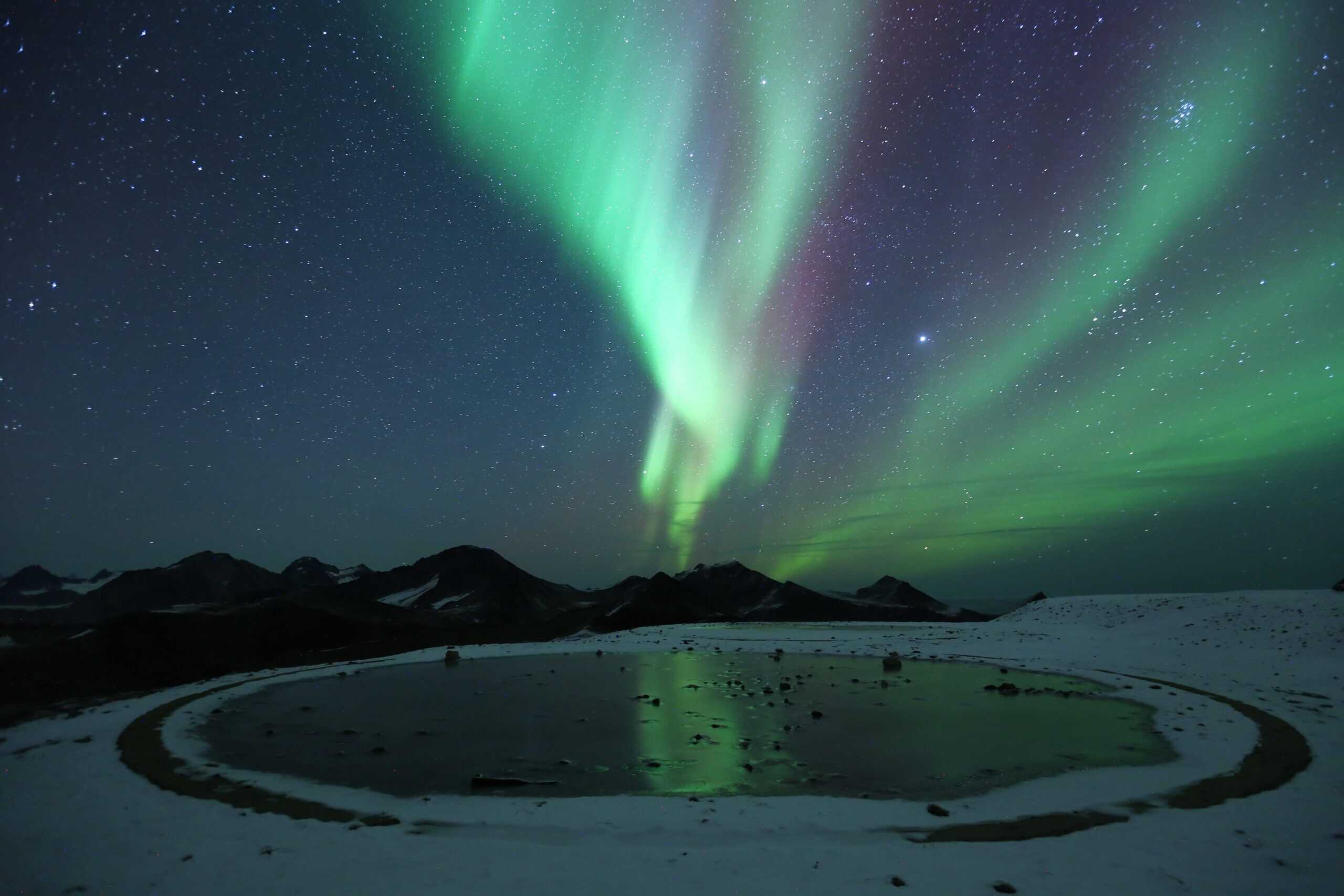 Northern Lights dancing over Kulusuk. Photo by David Broome