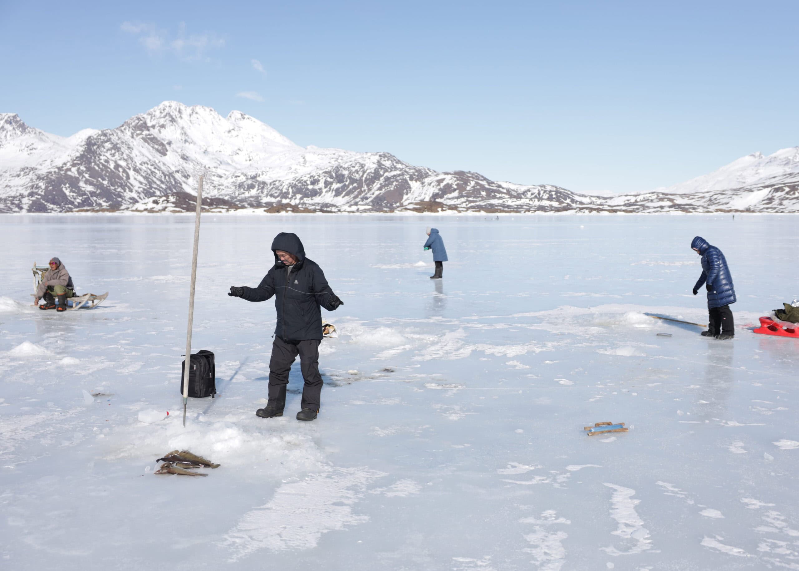 Ice fishing on the frozen fjord outside Tasiilaq.
