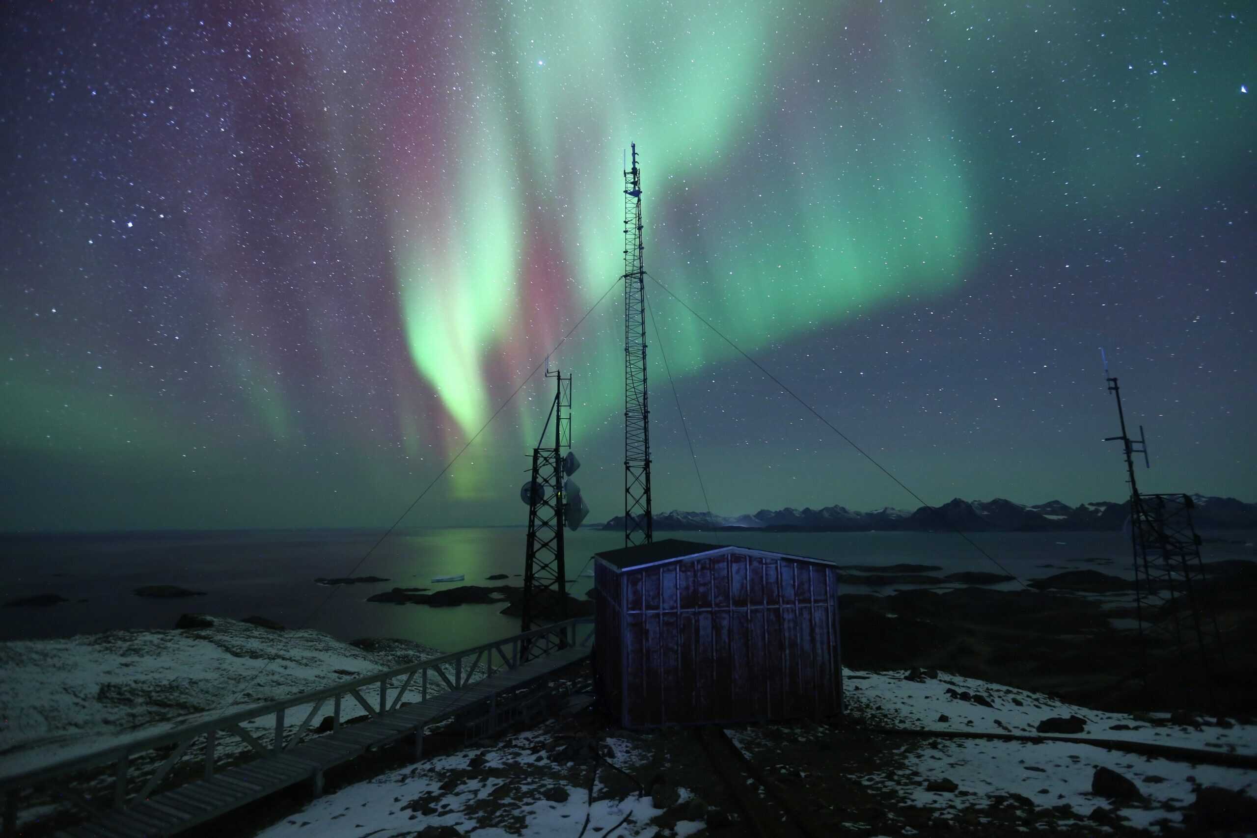 The Northern Lights reflected in Arctic waters in East Greenland, a mesmerizing harmony between earth and sky. Photo - David Broome, Visit East Greenland