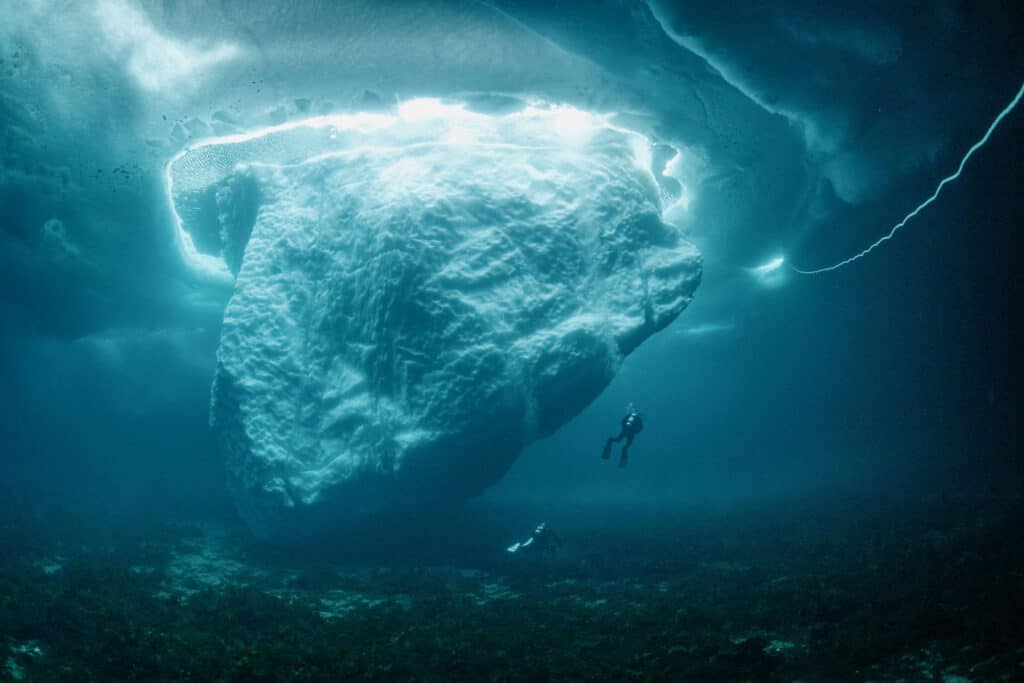 Diving next to a giant iceberg close to Kulusuk during winter.