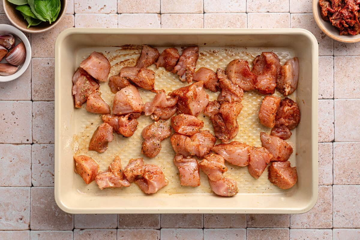 Overhead shot of chicken on baking sheet for recipe.