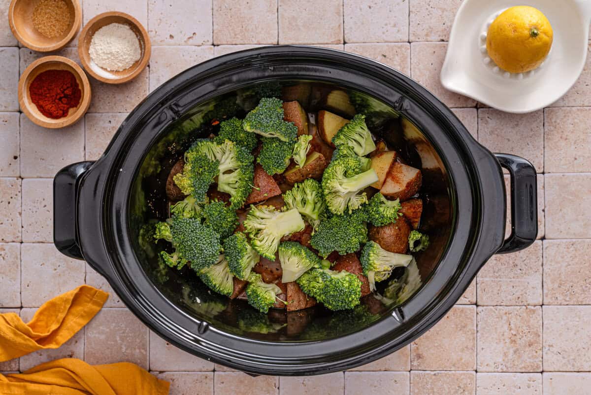 this shows me adding the brocoli on top of the potatoes 