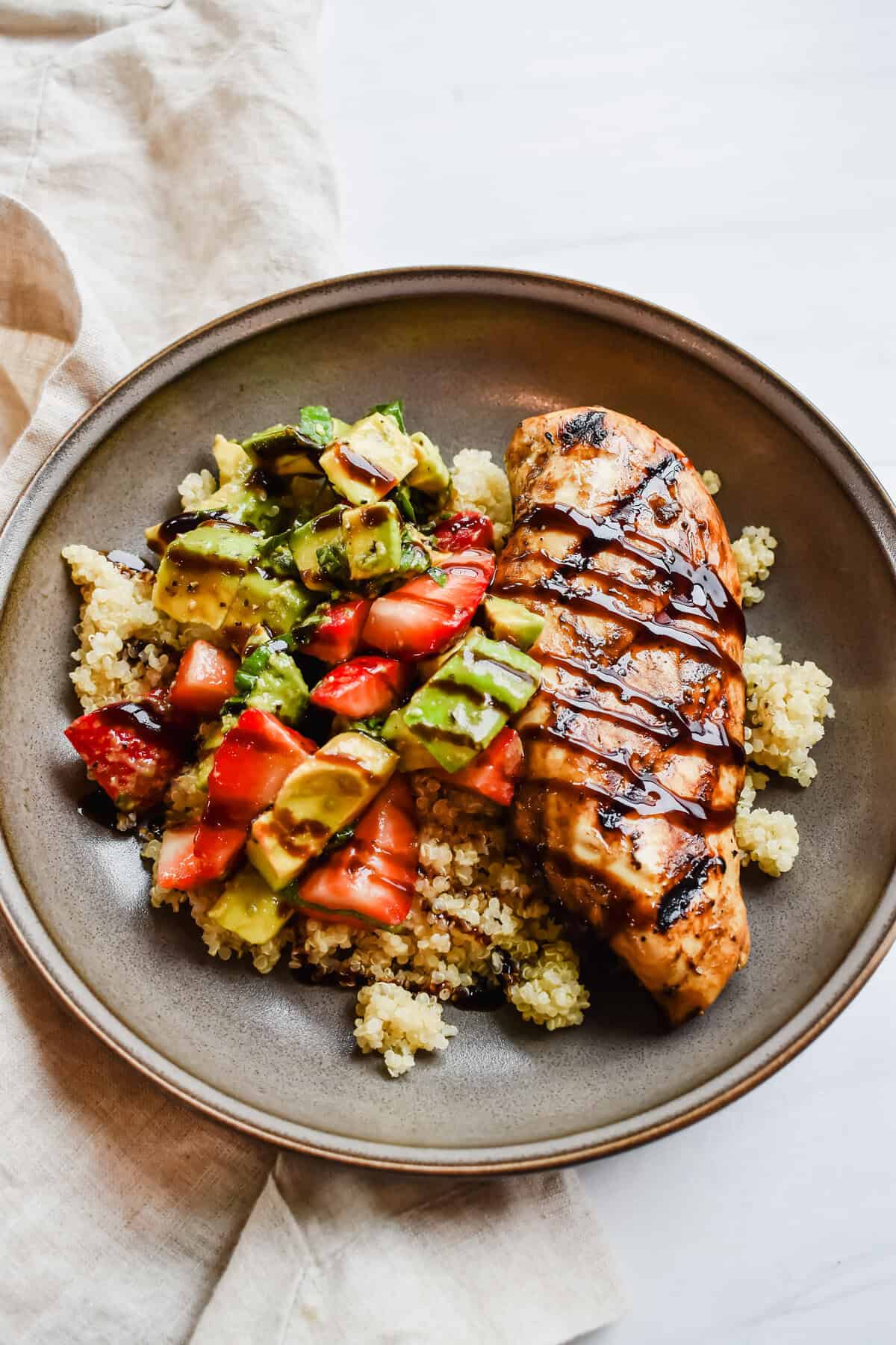 this is a side view close up of my grilled chicken with strawberry and avocado salsa. 