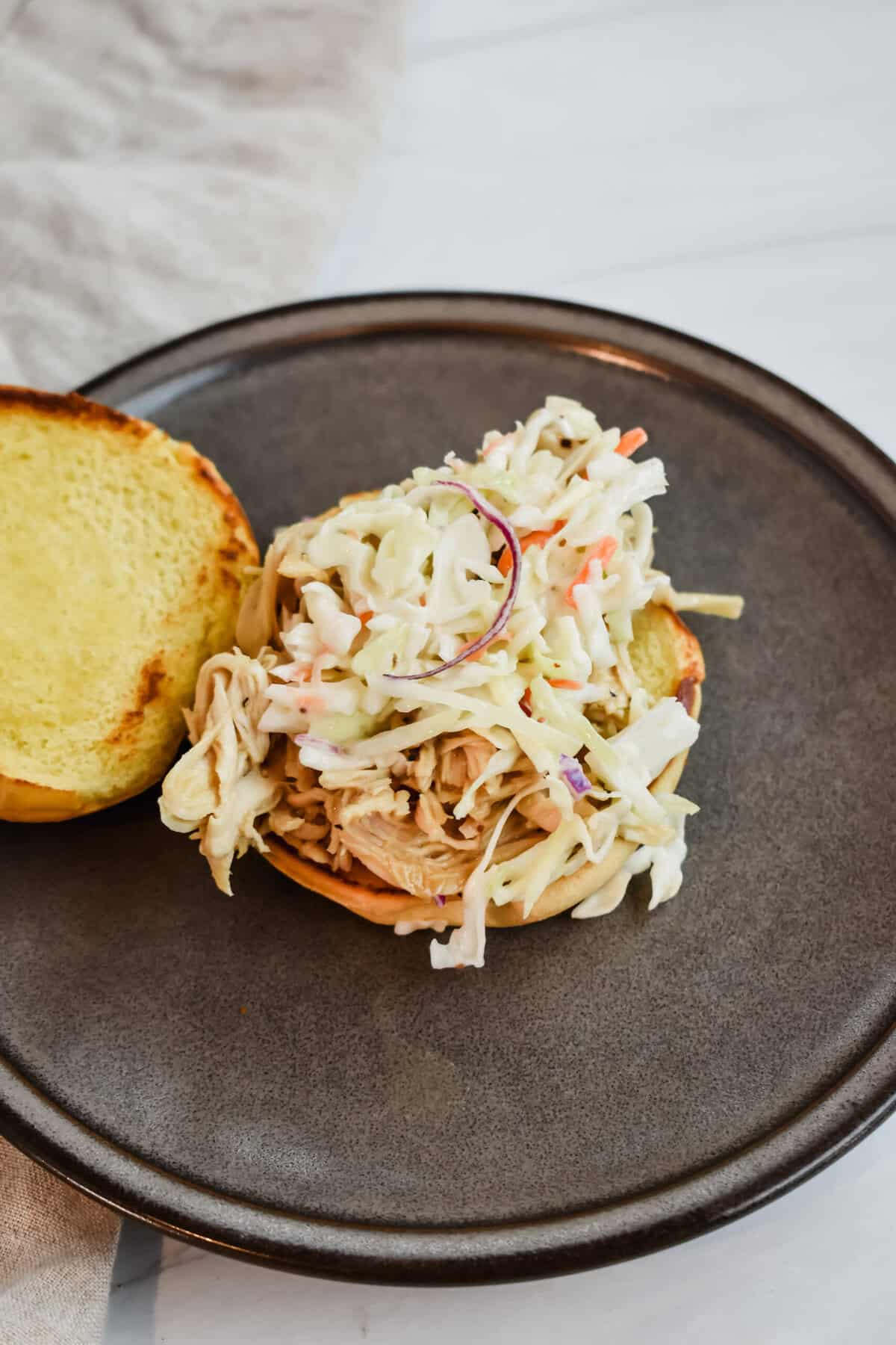 this is the sandwich opened up showing the coleslaw topping the chicken 