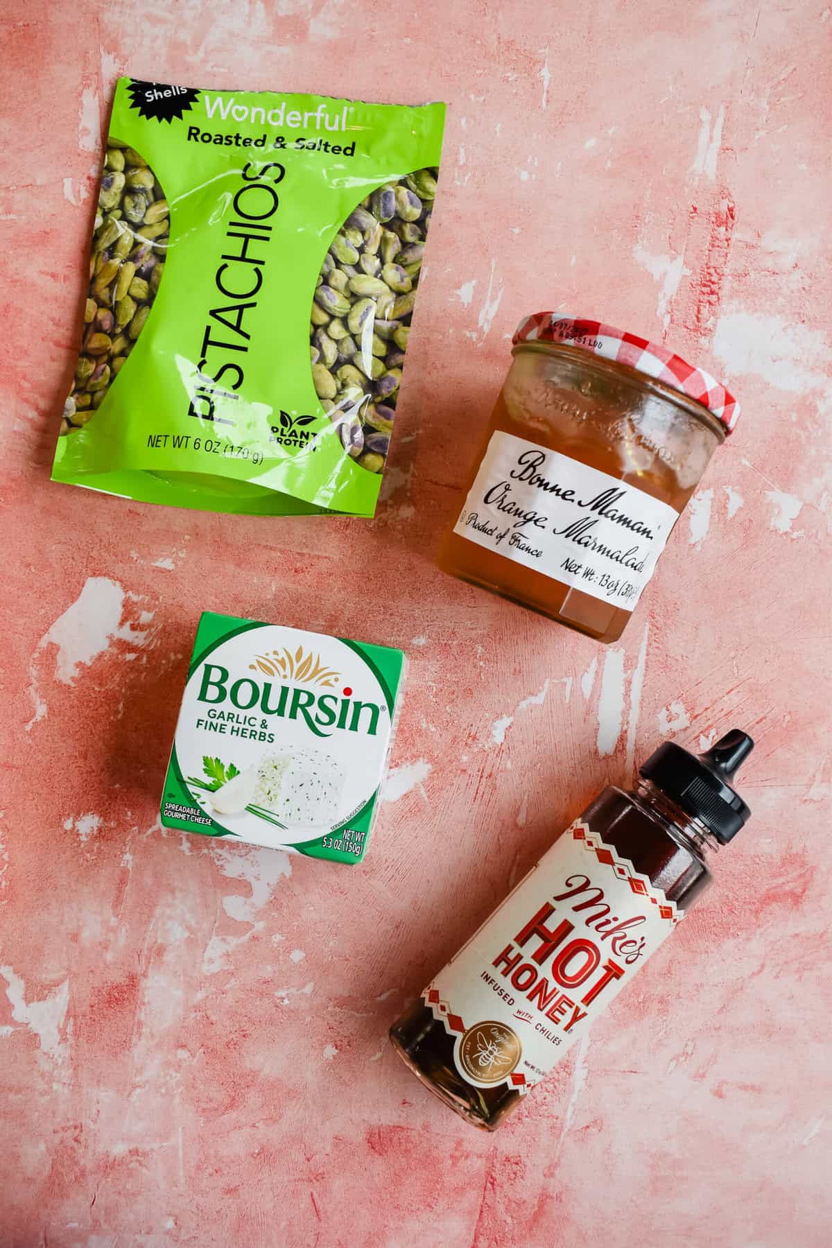 this is a photo of the ingredients. It has the pistachios, orange marmalade, boursin cheese and mikes hot honey. 