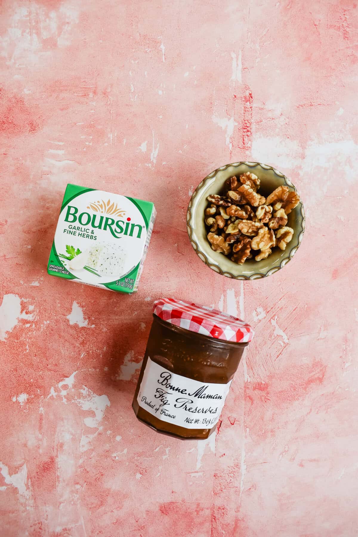 this shows the three ingredients in this boursin dip. the boursin cheese, the walnuts and the fig preserves 