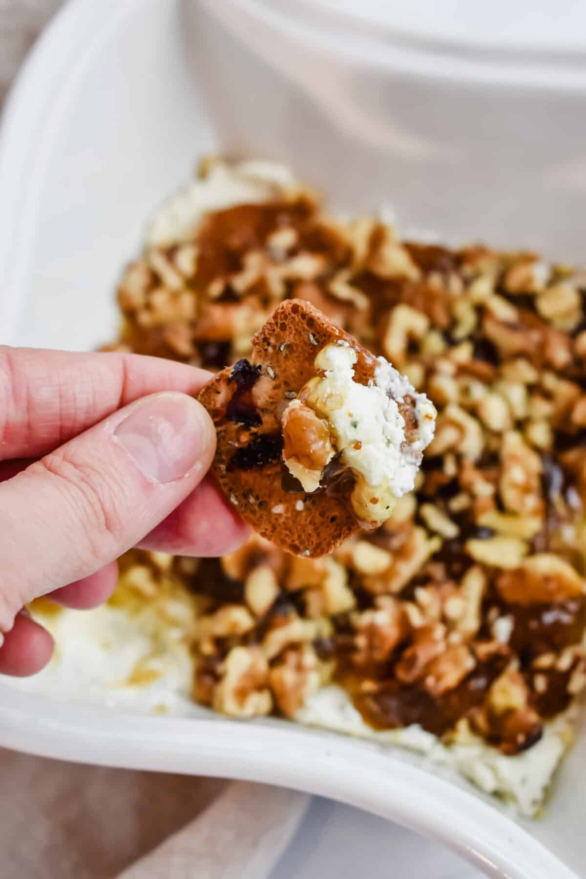 This is a photo of a close up of the boursin fig dip on a cracker