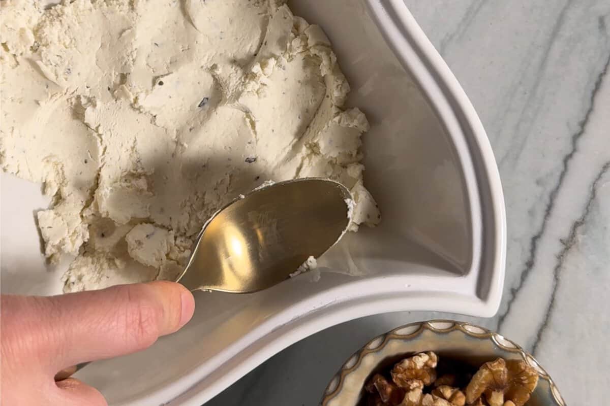 this shows me mashing down the boursin cheese with the back of my spoon 