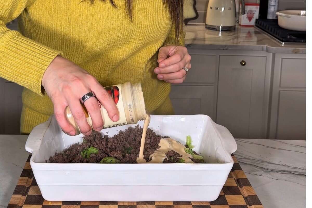 this shows me adding the alfredo sauce to the casserole dish with the other ingredients. 