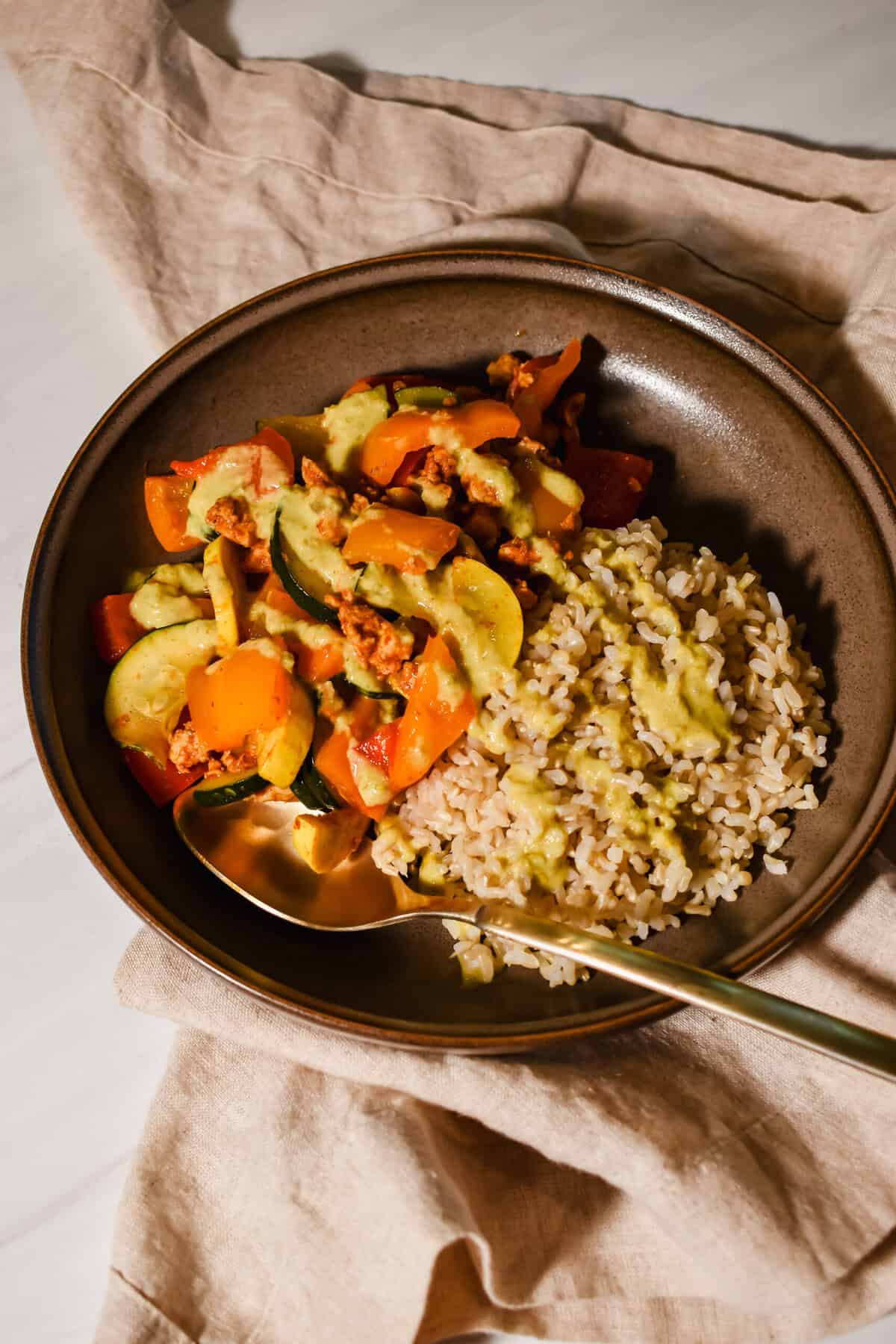 Easy and healthy Mexican stir fry plated with creamy jalapeño sauce.