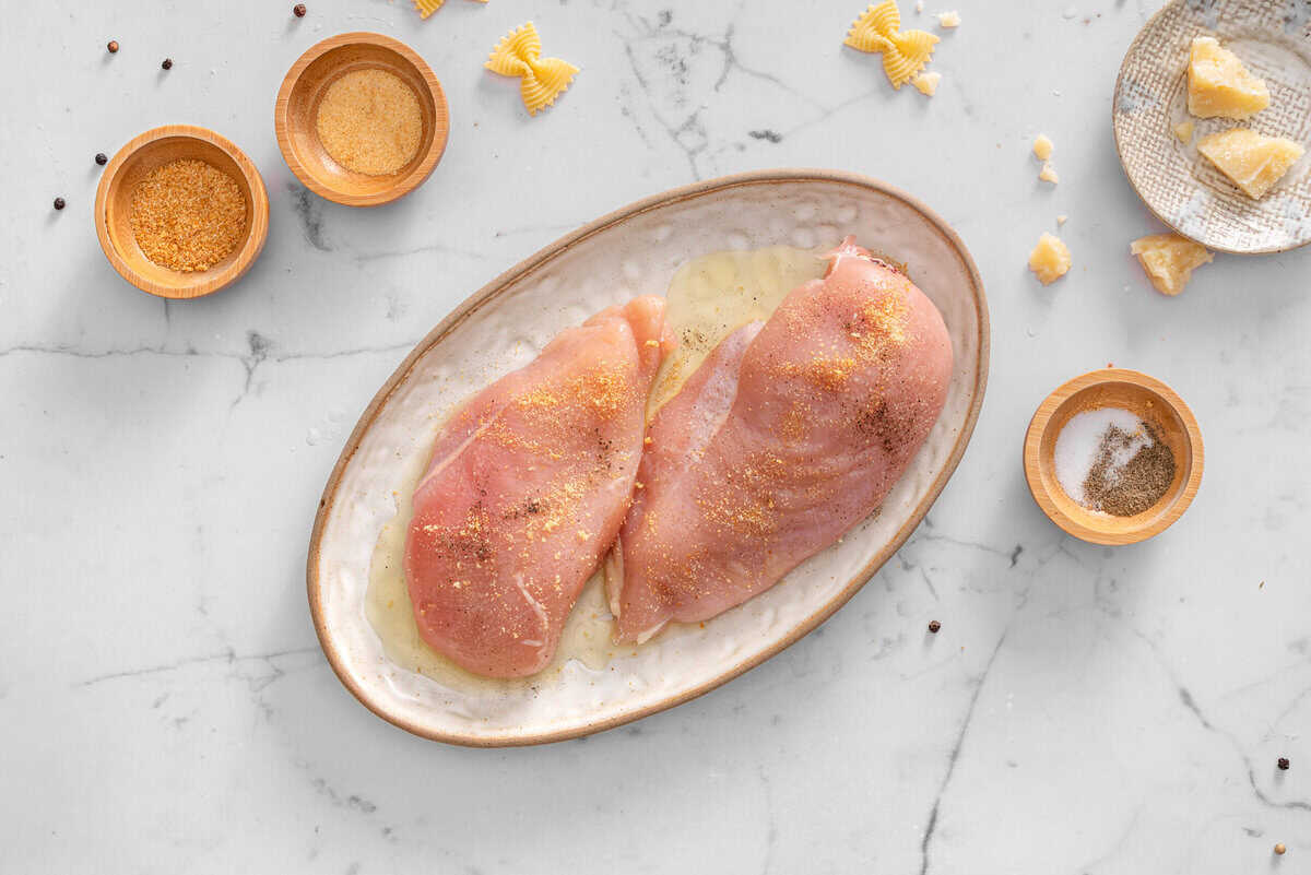 this shows the chicken getting seasonings.