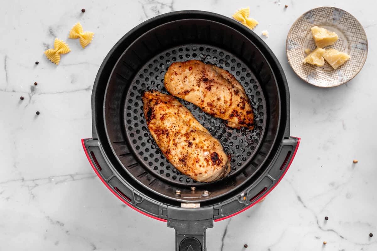 this shows the chicken being cooked in the air-fryer