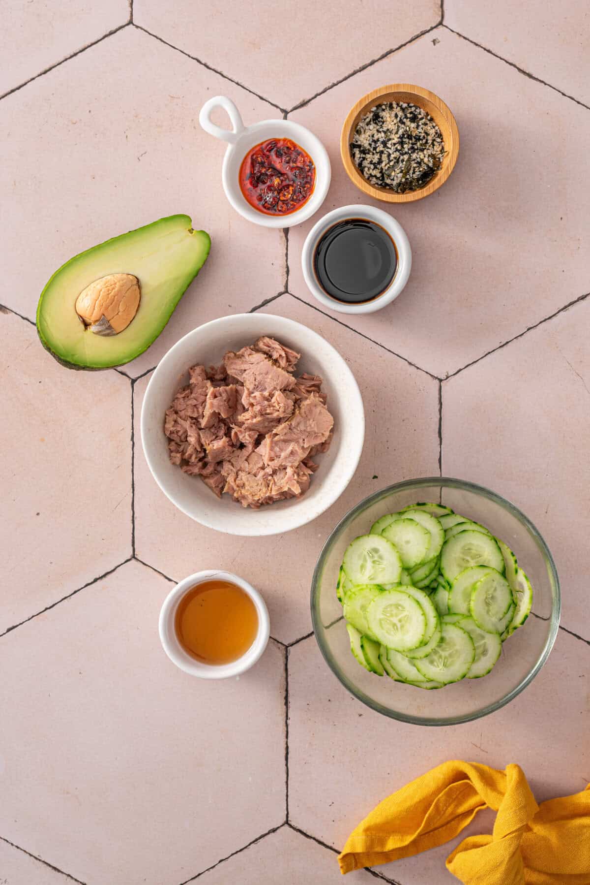 A overhead shot of the ingredients used for tuna cucumber salad.