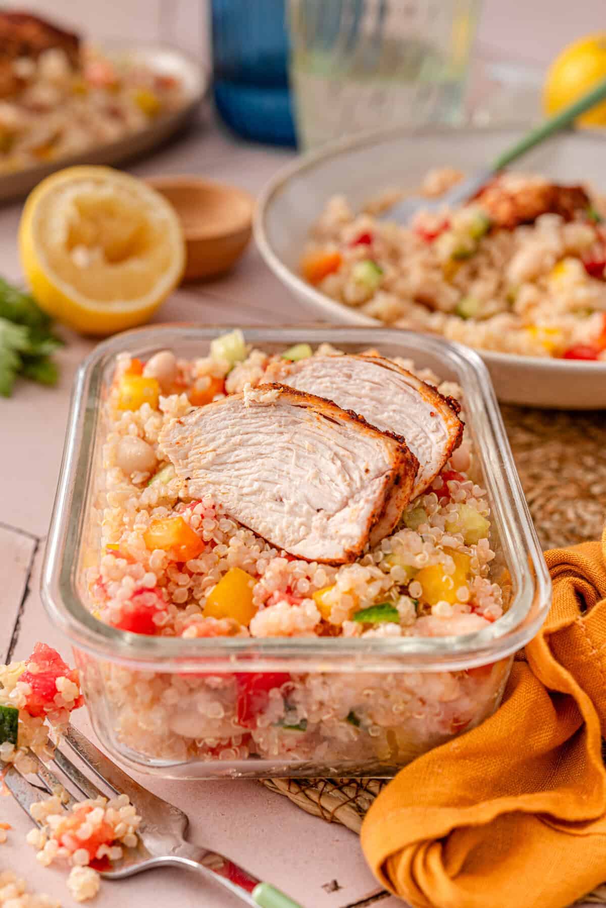 Side angle shot of garbanzo and quinoa salad in meal prep container.