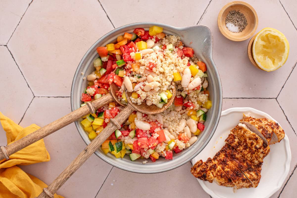 Overhead shot of all ingredients in bowl for garbanzo and quinoa salad.