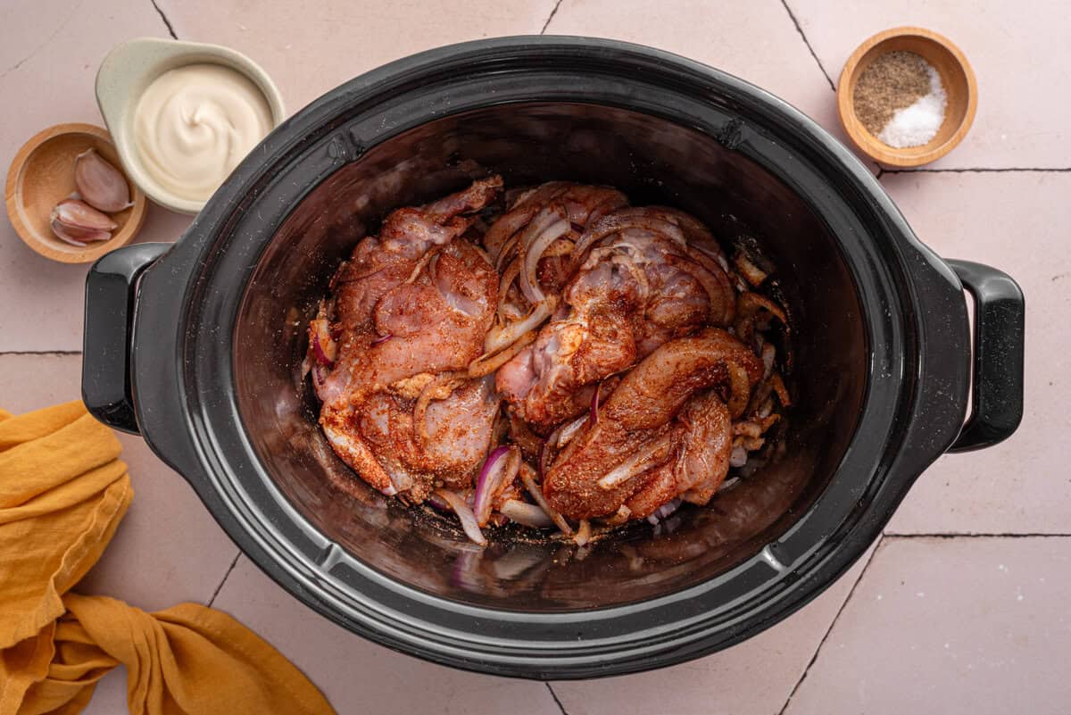 Over head shot of seasoned raw chicken.