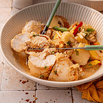Descriptive photo of coconut red curry chicken and potatoes.