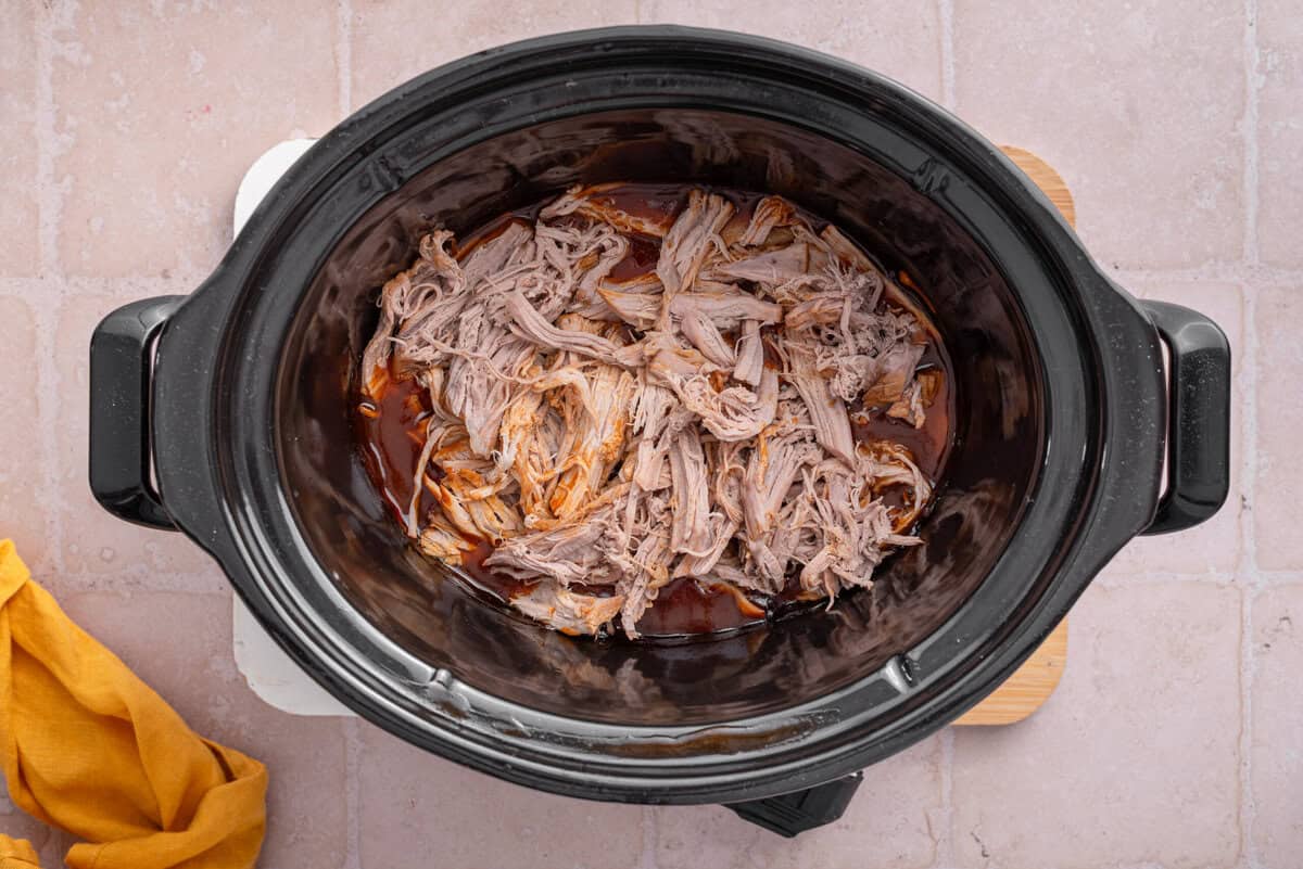 Overhead shot of pork shredded with bbq sauce.