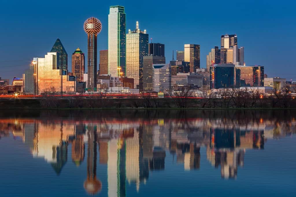 Downtown Dallas skyline at dusk reflected in the water