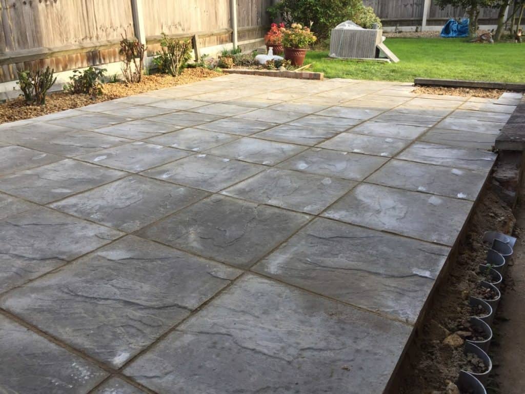 Newly laid stone patio in Suffolk garden by EM Fencing and Garden Services.
