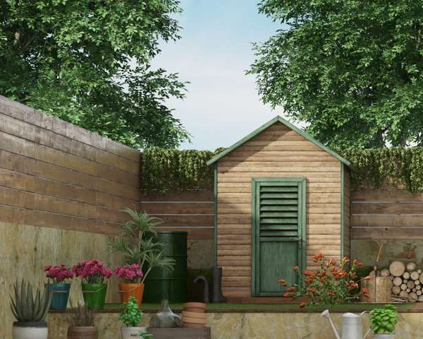 Garden shed with fencing, plants, and logs in a backyard setting.