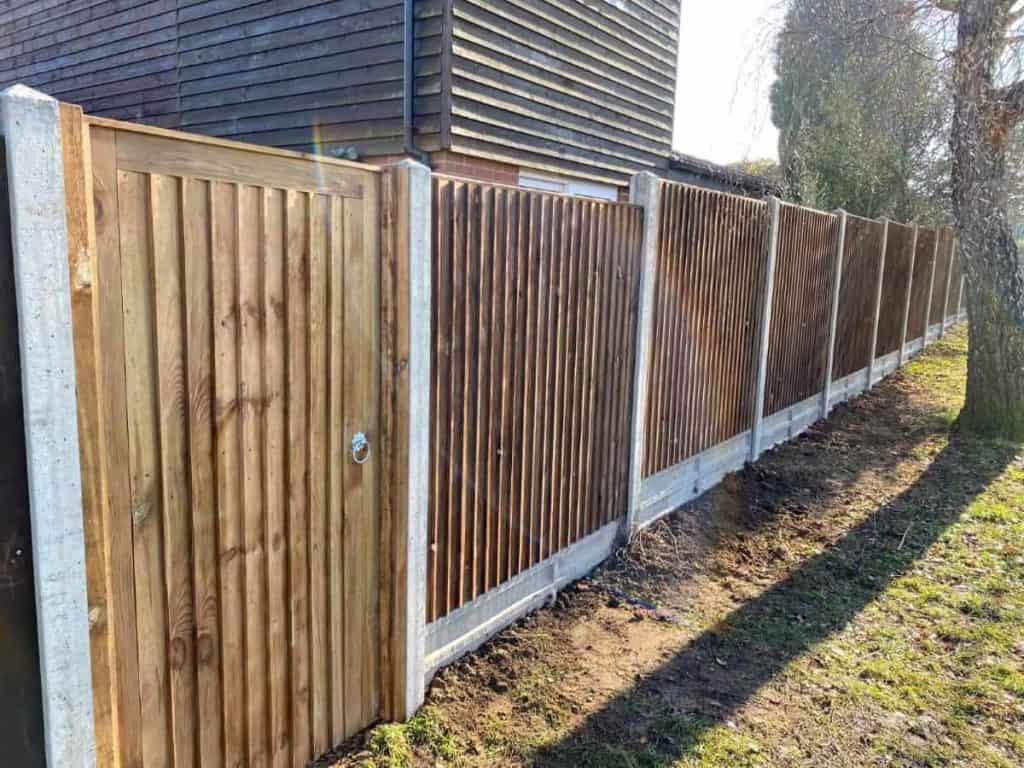 New wooden garden fence with concrete posts and panels.