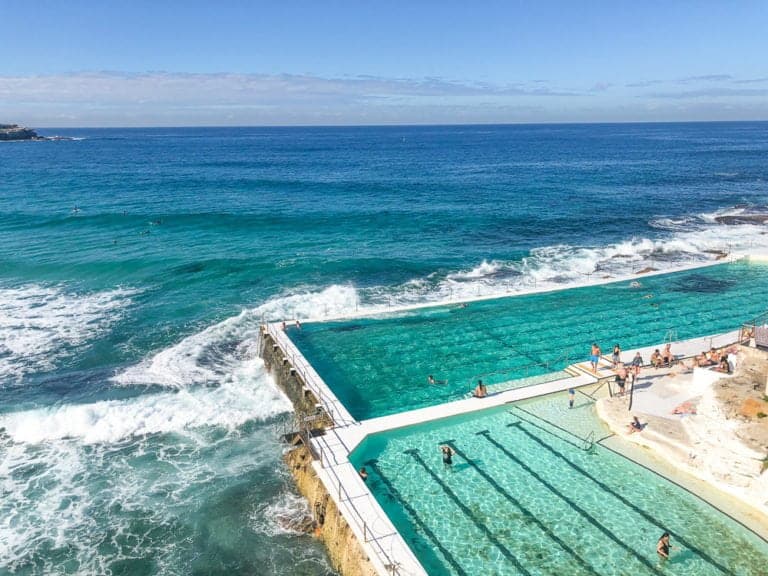 The Bondi Icebergs ocean pool carved in to a cliff face with waves crashing into the pool edges. This view is iconic.