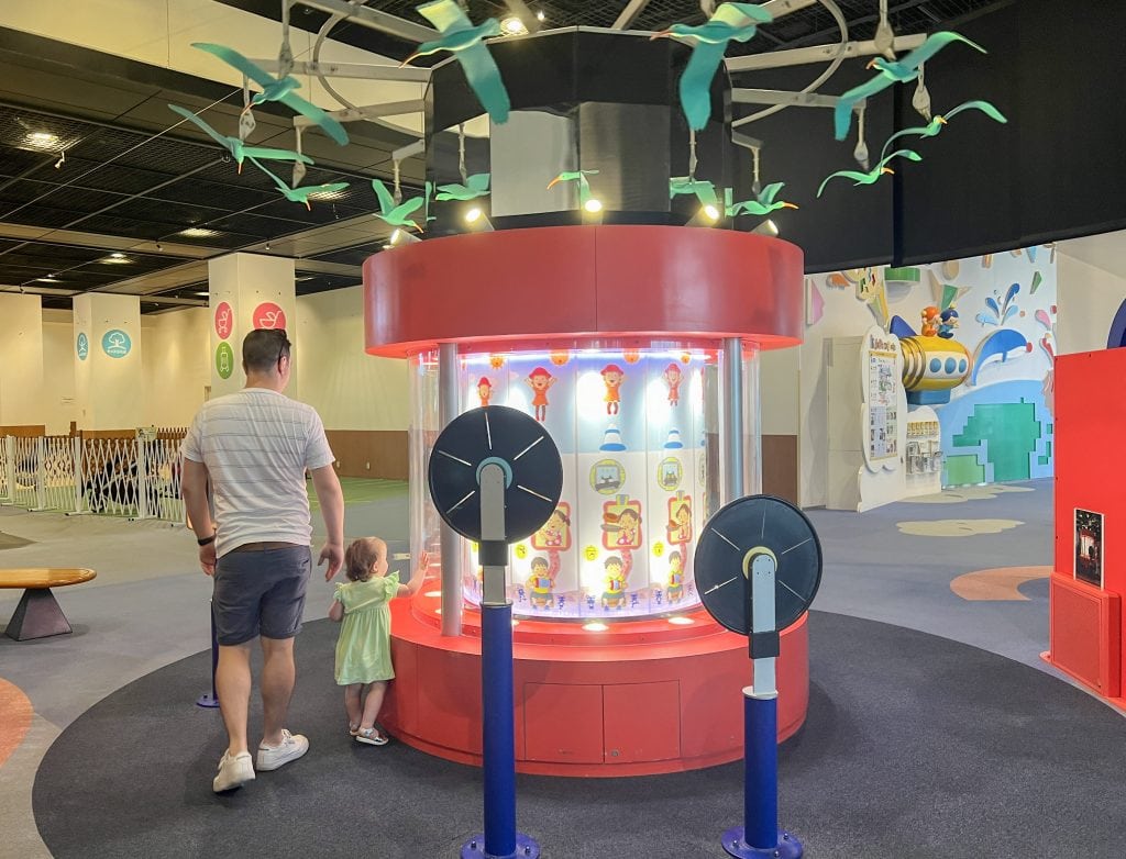Family enjoying interactive play area at Osaka Kids Plaza with children exploring fun exhibits and engaging activities.