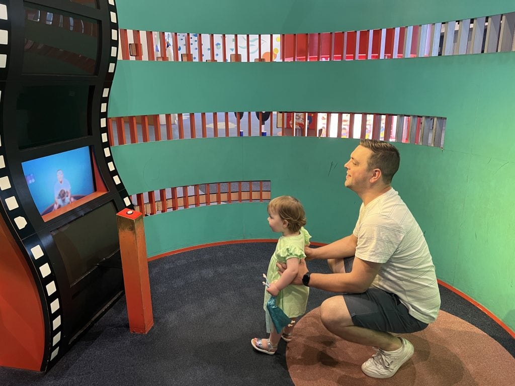 A father and young girl enjoying interactive play at Osaka Kids Plaza, exploring fun exhibits and engaging in family-friendly activities in a vibrant indoor play area.