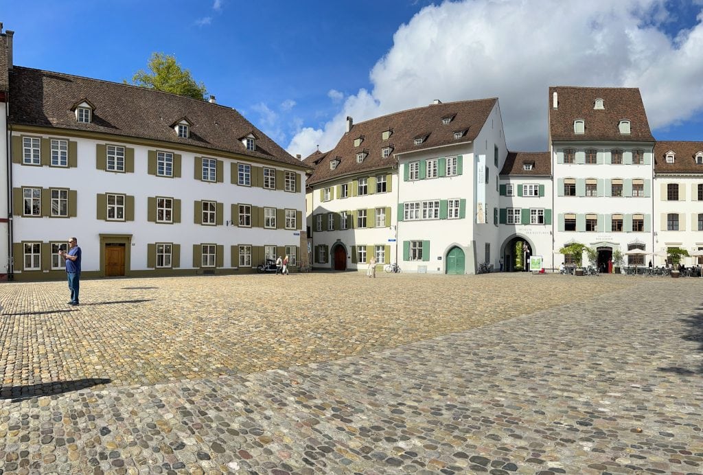 A vibrant view of Basel's historic old town with colorful medieval buildings and cobblestone streets, perfect for exploring with kids on a day trip from Zurich.