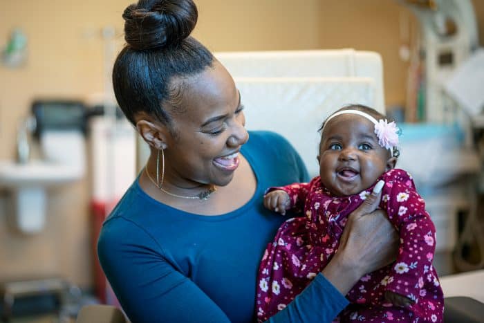 Black woman holding baby
