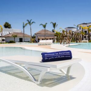 Poolside lounger with towel.