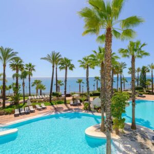 Palm trees by blue swimming pool