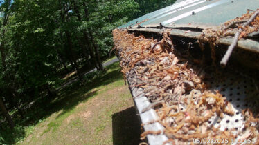 Close-up of a gutter clogged with leaves and debris in Cincinnati, Kentucky.