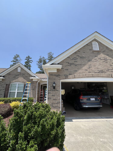 Highly visible image of a residential gutter system with maintenance ladders, showcasing the pride in gutter installation services.