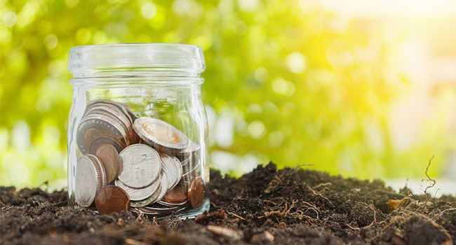 Money in the glass with filter effect retro vintage style,Coins in jar with saving, retirement and emergency plan label - financial concept,business background,money content and selective focus.