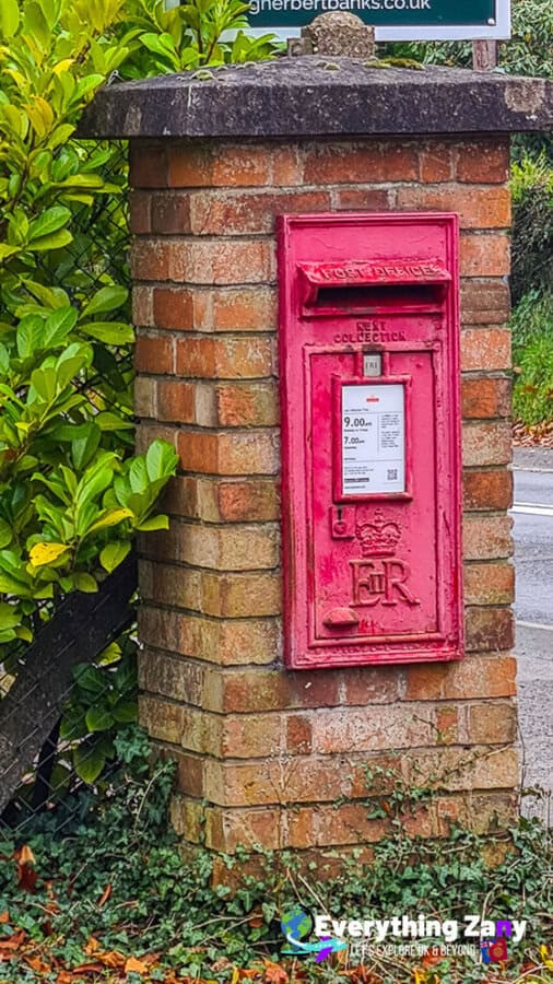 Red wall-mounted British post box with Queen Elizabeth II's EIIR royal cypher.