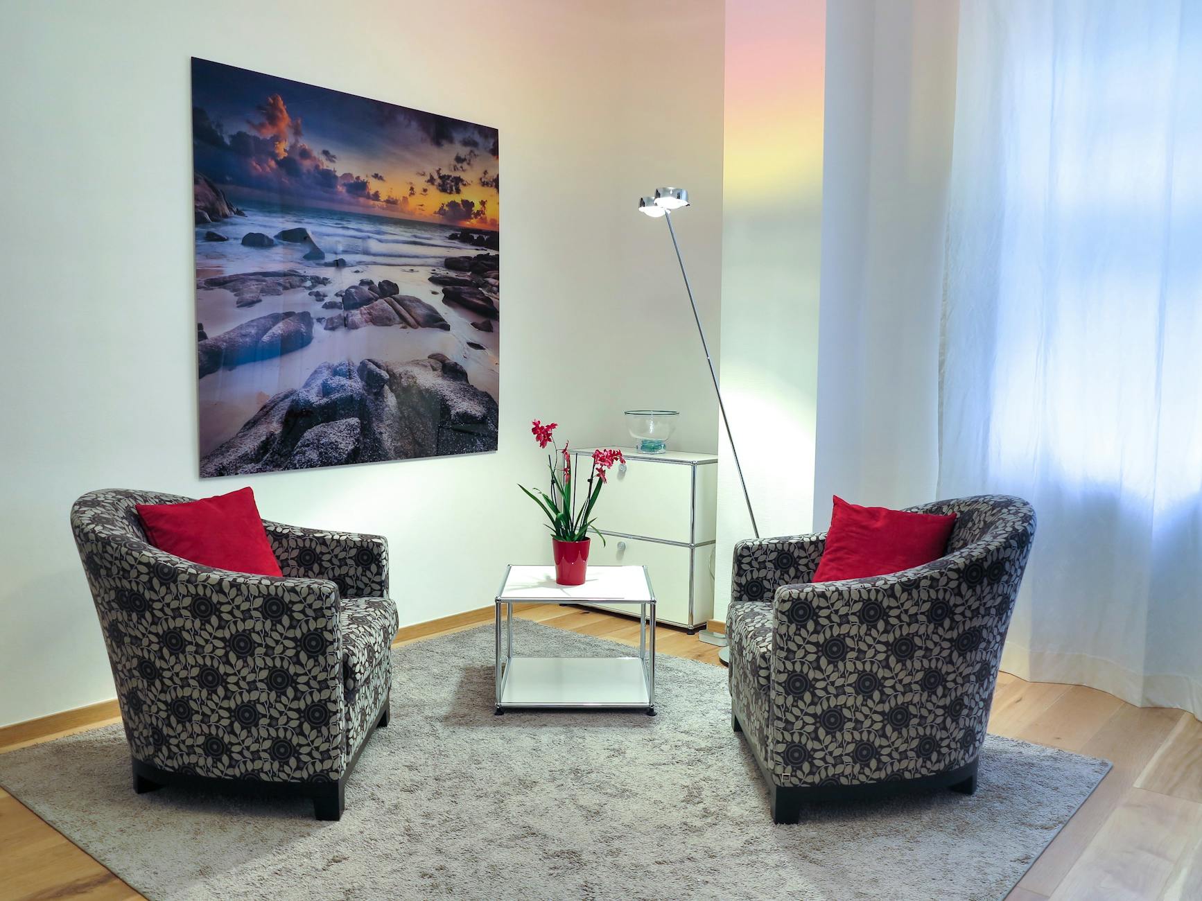 Elegant living room showcasing modern chairs, art, and decor for a stylish home setup.