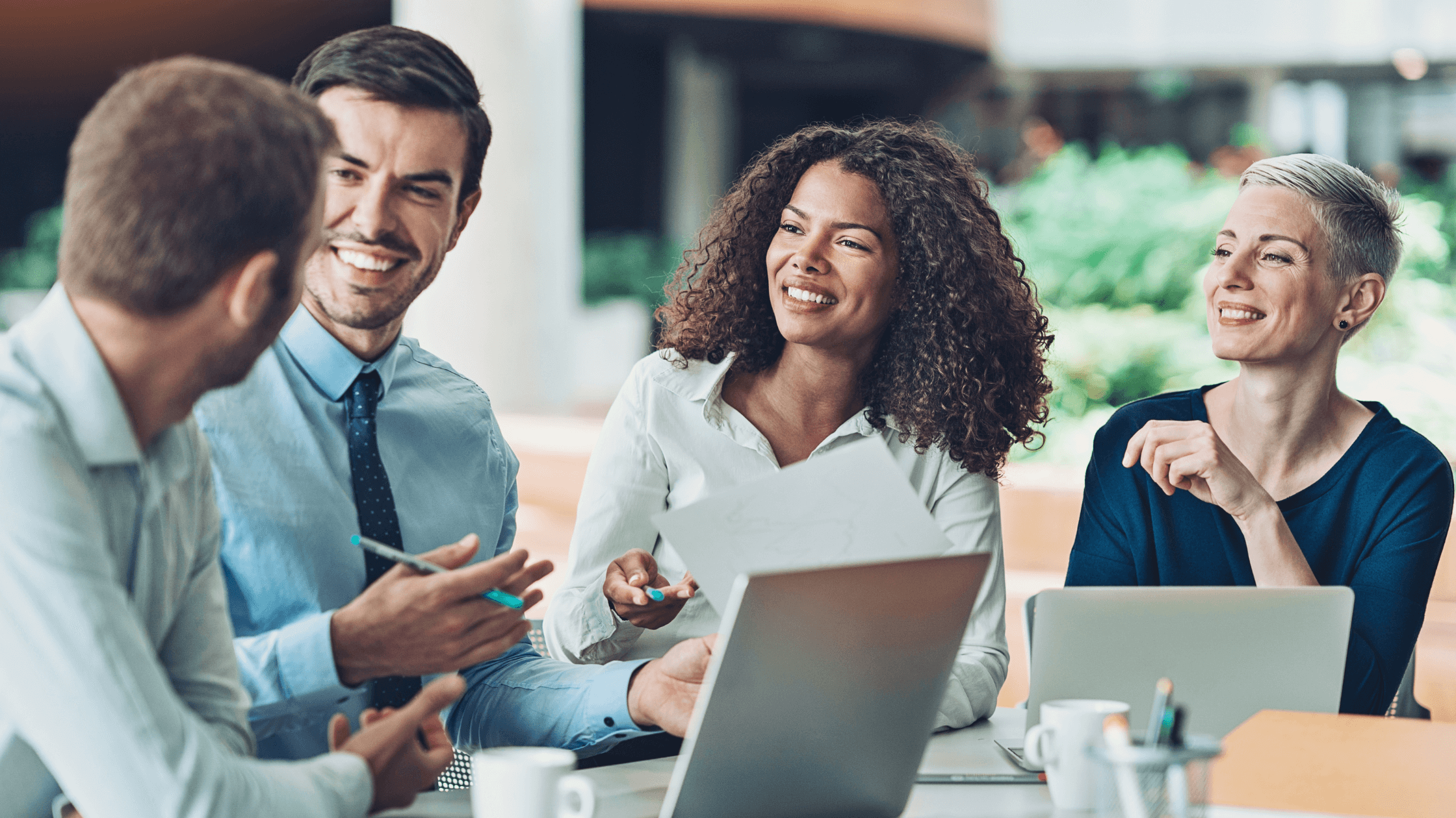 A diverse, strong management team meeting, demonstrating a sellable company that can run without the owner's presence.