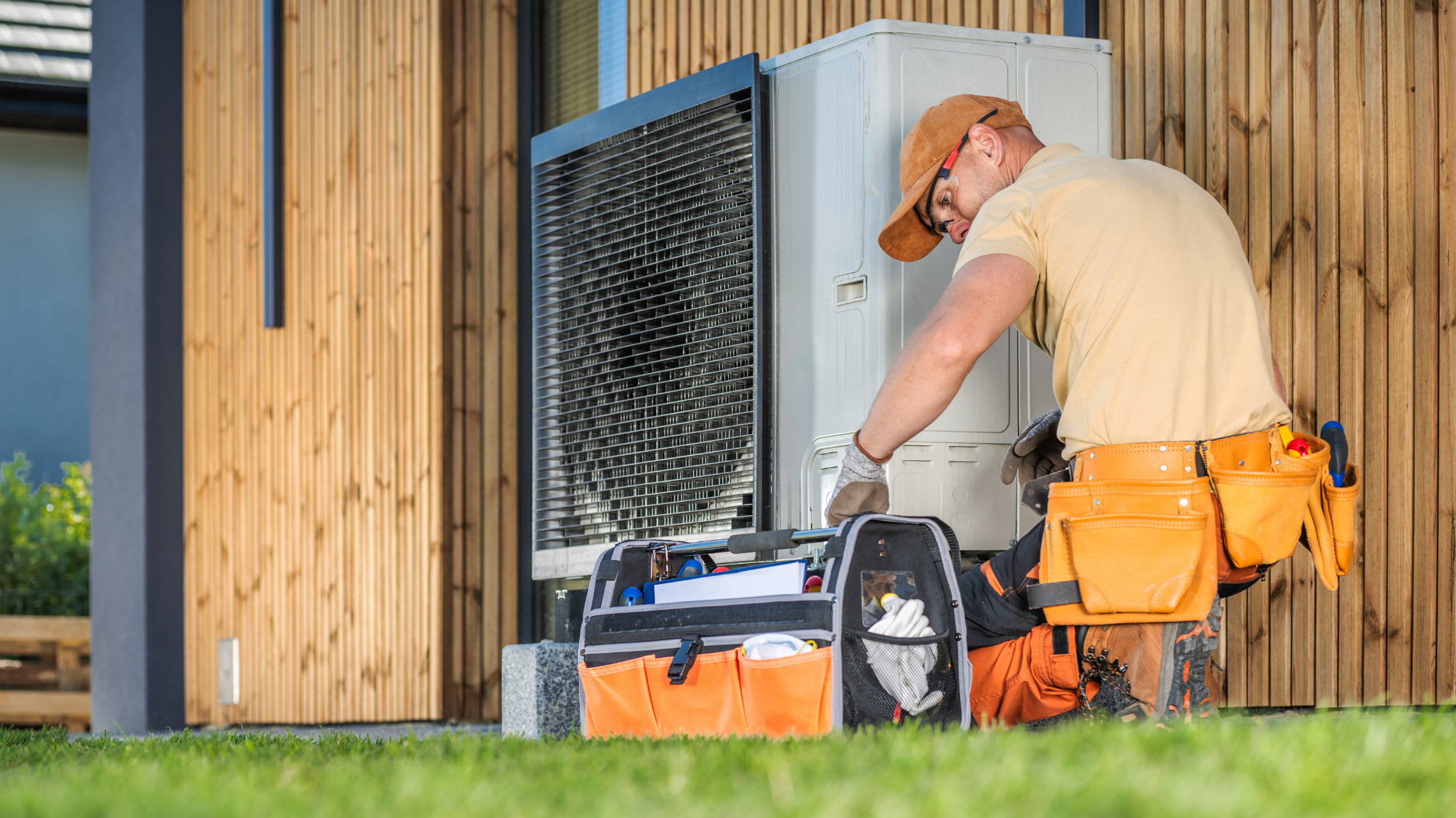 A technician servicing an outdoor HVAC unit, representing the valuation of an HVAC business when preparing to sell