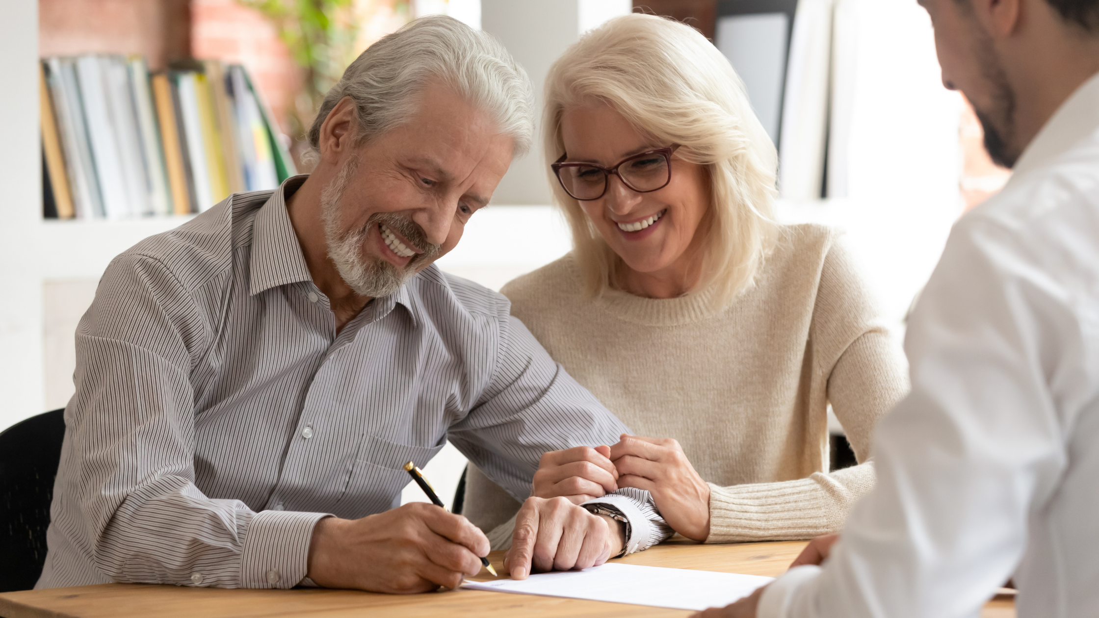 An older couple reviewing business valuation information together, representing how industry valuation multiples are used to value a company in 2026