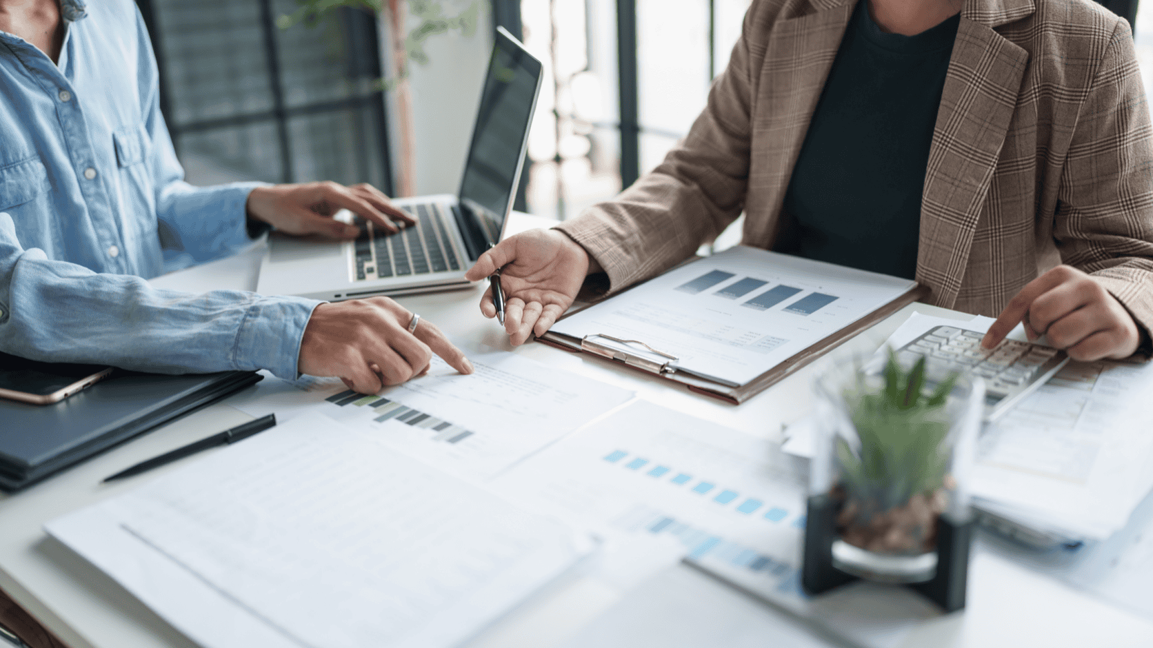 Business owner and advisor analyzing revenue charts to assess customer concentration risk