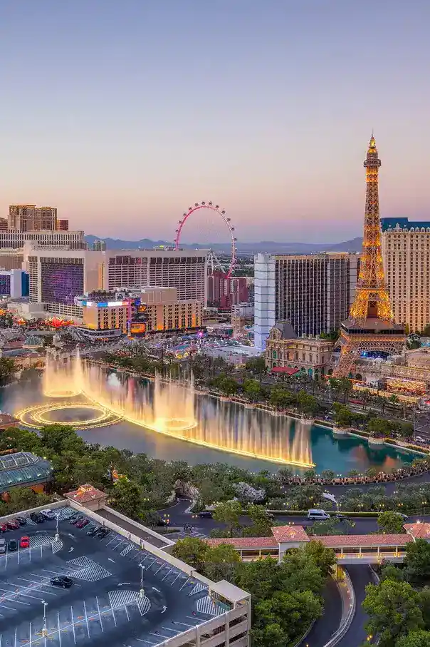 Vibrant Las Vegas cityscape featuring the Eiffel Tower replica, fountains, and colorful lights at du.