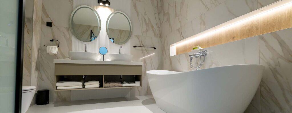Elegant bathroom featuring a stylish freestanding bathtub and contemporary design elements.