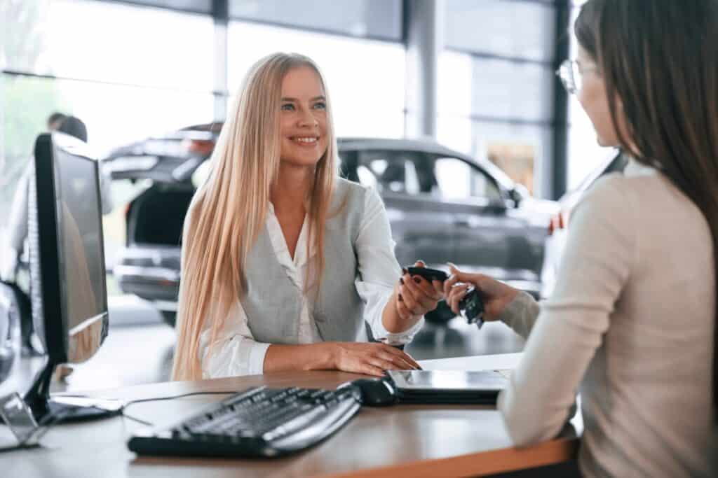 Service advisor handing car keys back to a customer after a service, automotive customer advocacy case study